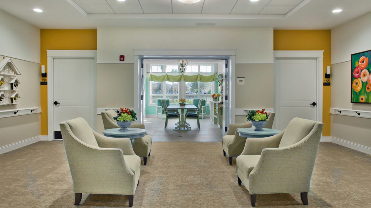 A bright and welcoming lobby with comfortable seating and floral decorations.