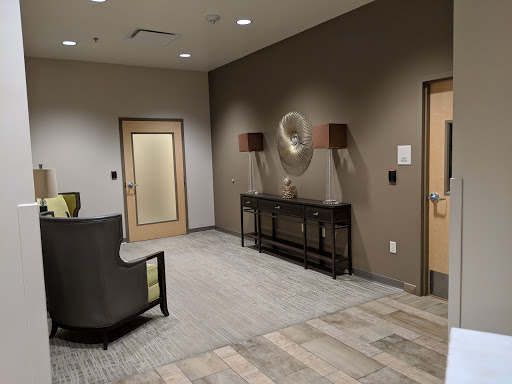 A modern interior lobby featuring a seating area and stylish wall decor.