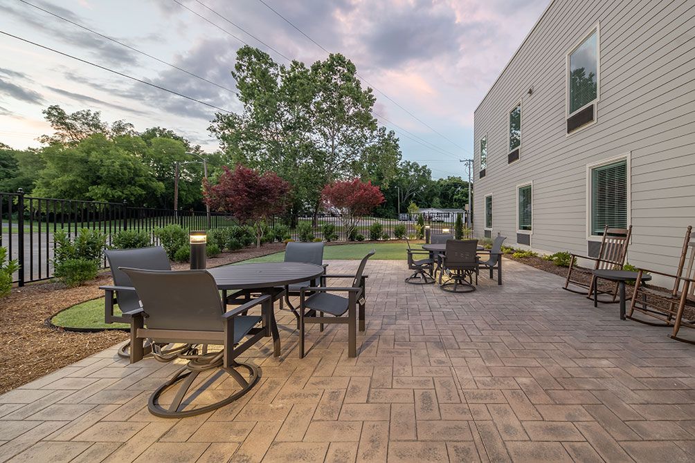 A spacious outdoor patio with seating and garden views.