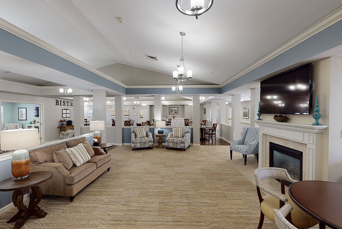 A cozy and elegantly decorated living room with comfortable seating and a fireplace.