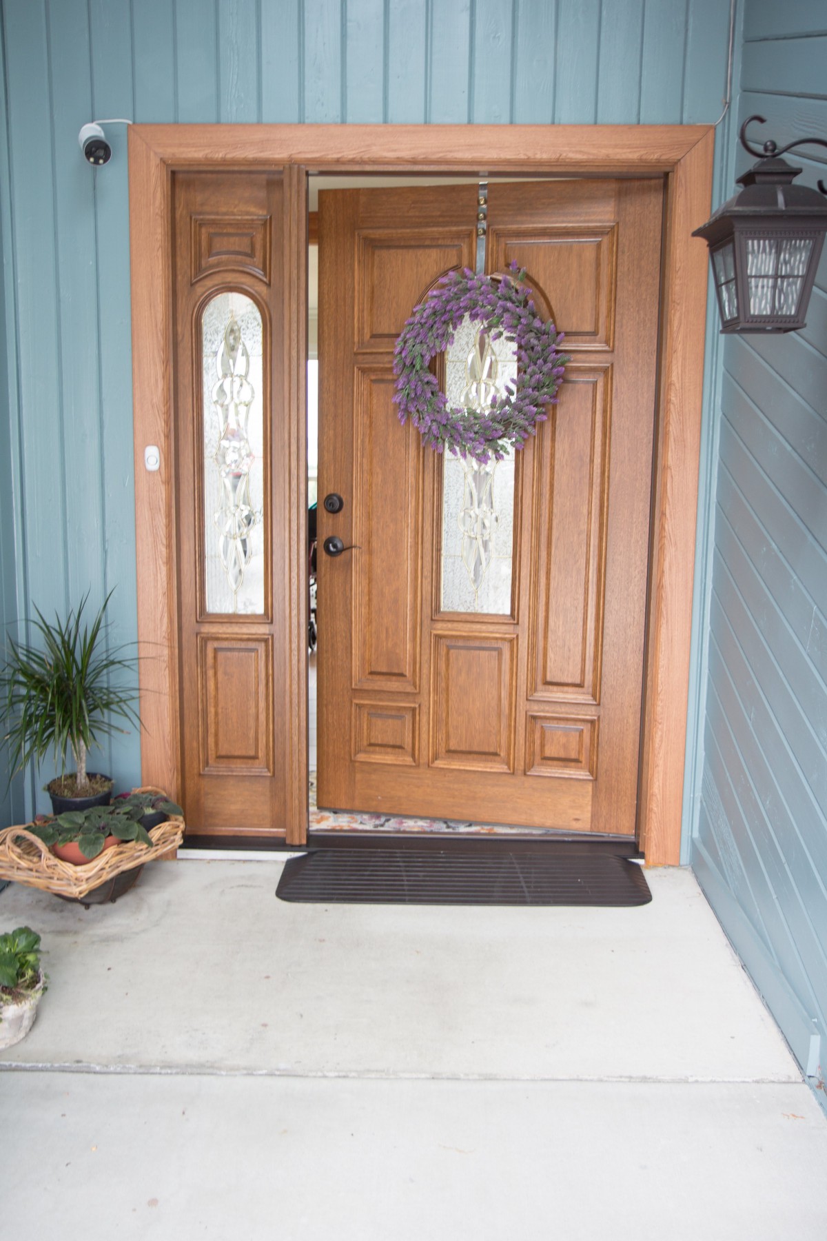 A welcoming entrance with a wooden front door adorned with a wreath.