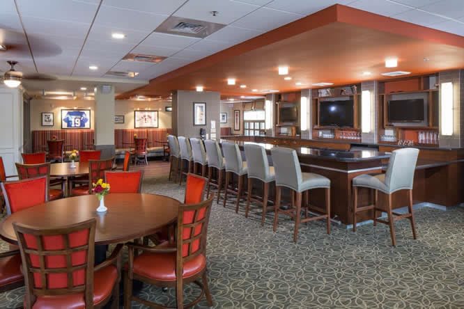 A modern restaurant and bar interior with ample seating and a stylish counter area.