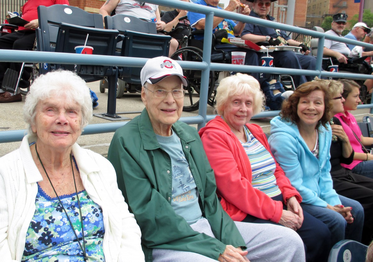 A group of people seated outdoors, enjoying a day out.