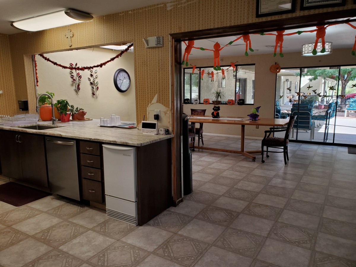 A decorated indoor kitchen area with festive balloons and garlands.