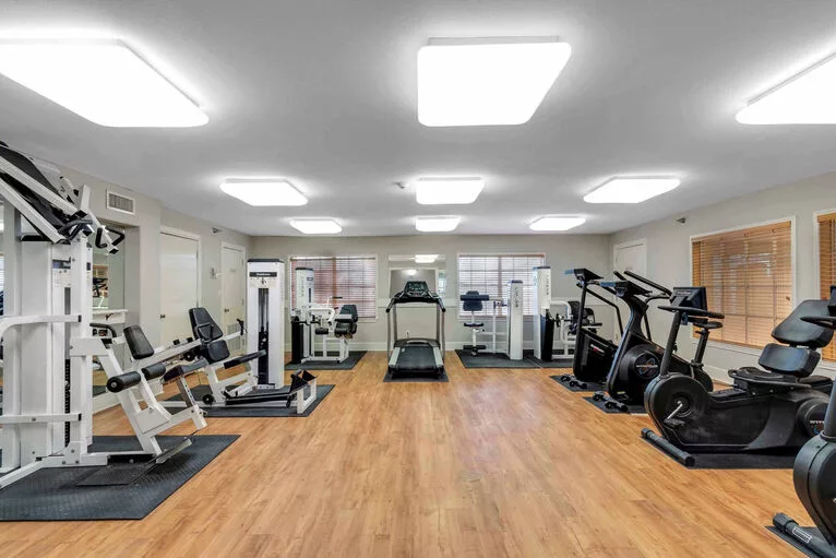 A well-equipped gym with various fitness machines and exercise equipment.