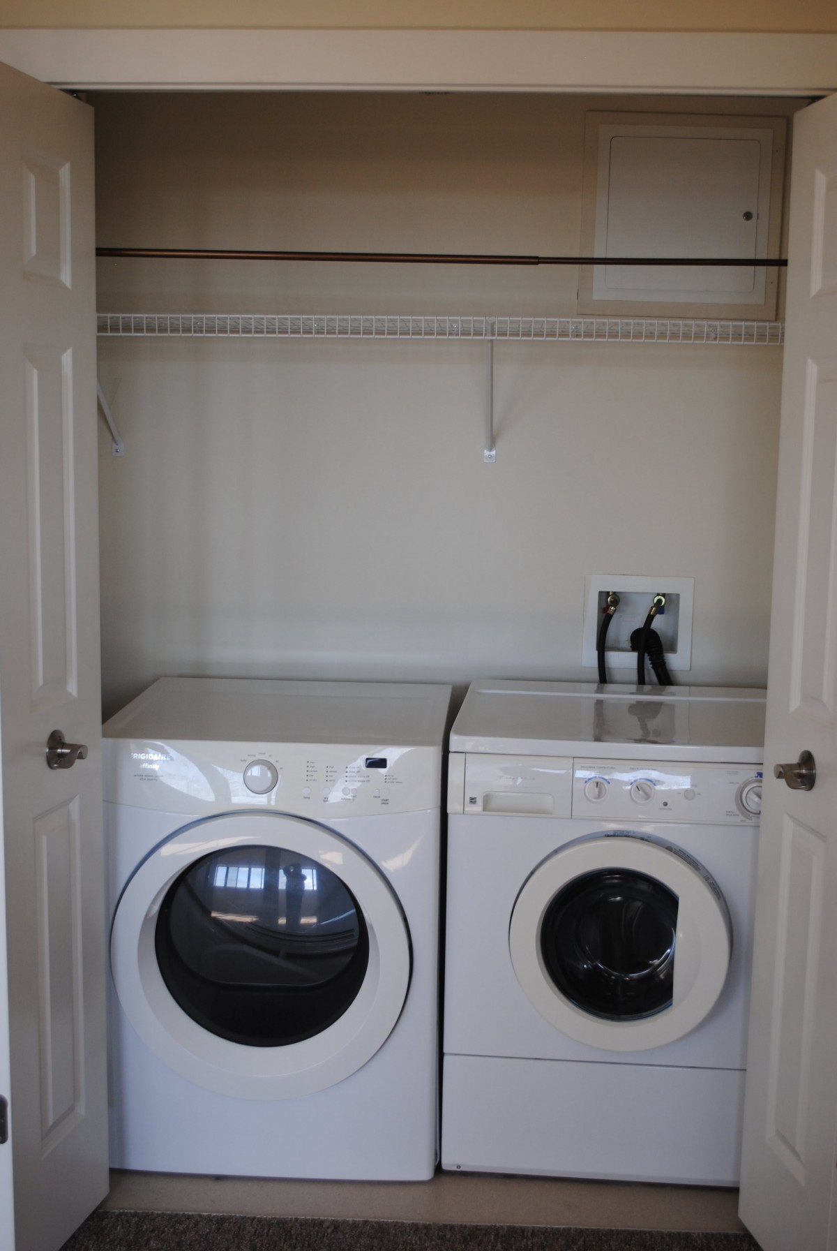 A minimalist laundry room with a washer and dryer set.
