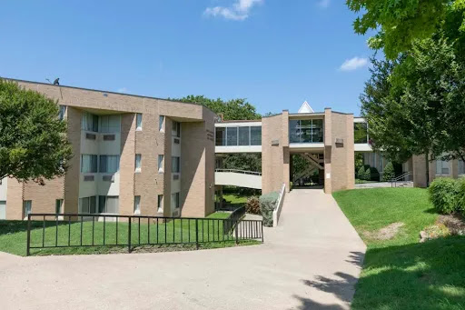 A view of a modern academic building situated on a well-maintained campus.