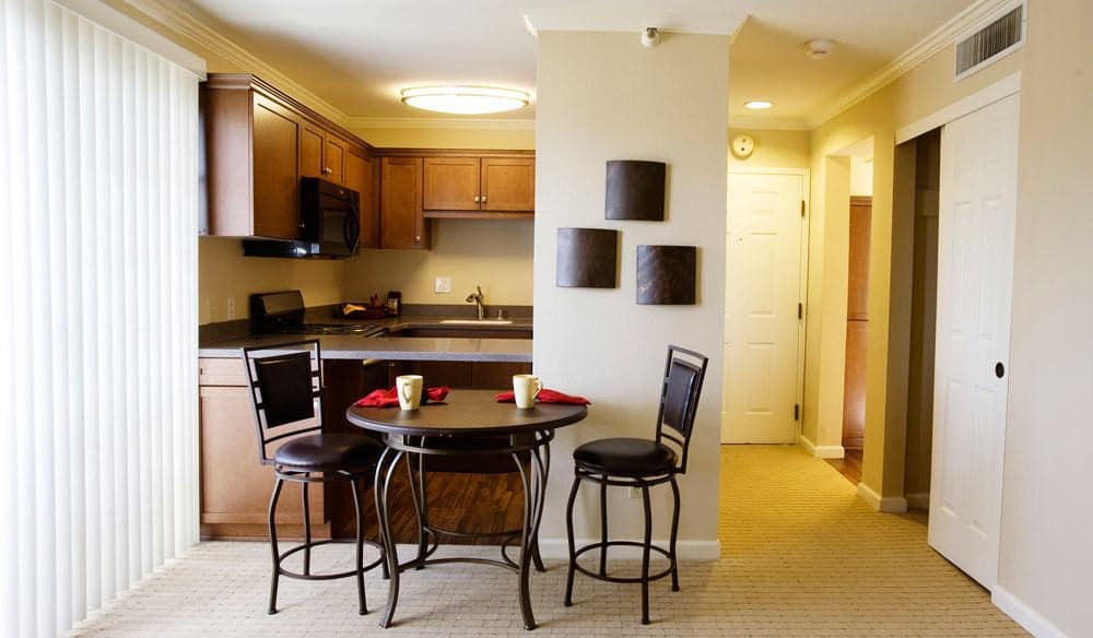 A cozy kitchen and dining area with a modern table set.