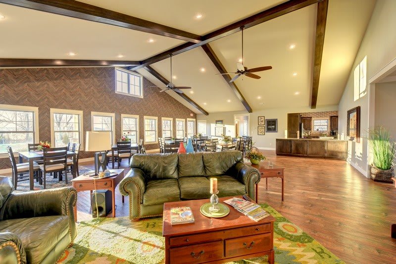 Spacious living room with wooden beams and a cozy seating area.