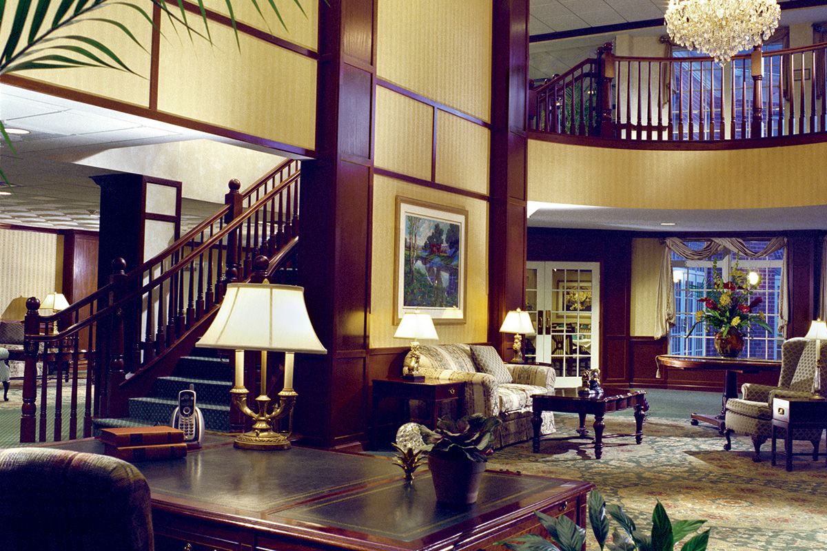 A well-furnished lobby with elegant decor and a staircase.