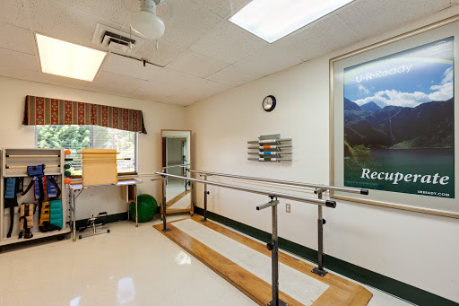 A well-equipped physical therapy room featuring ballet bars for rehabilitation exercises, designed to promote patient recovery.