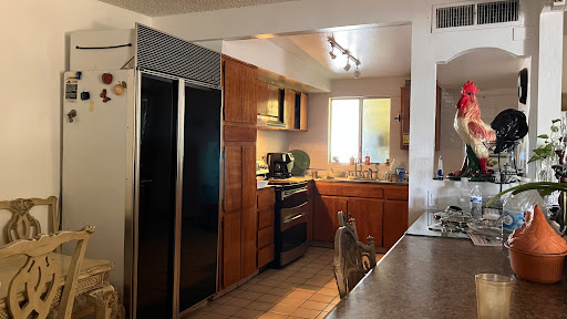 A modern kitchen featuring wooden cabinets and stainless steel appliances.