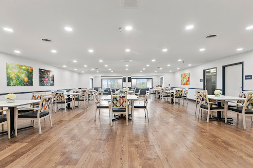 A spacious and modern dining area featuring well-lit interiors, elegant tables, and comfortable chairs.