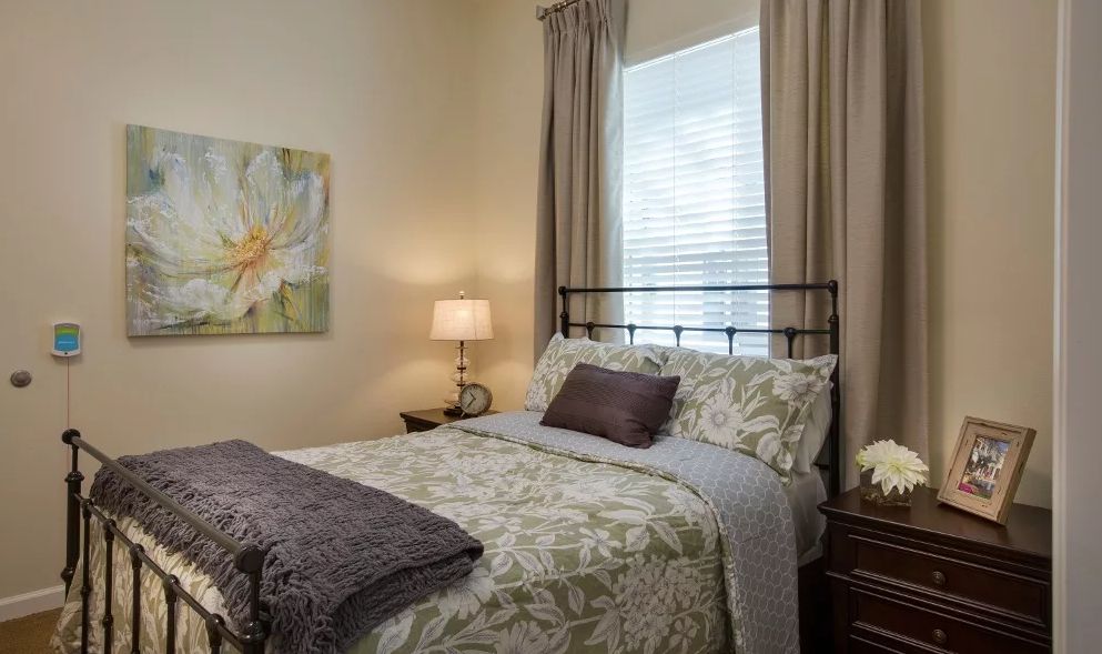 Cozy bedroom with decorative bedding and warm lighting.