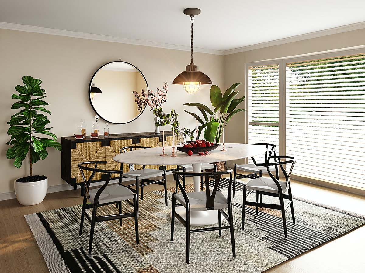 A modern dining room featuring a round table, stylish chairs, and a large mirror, complemented by houseplants and natural light.