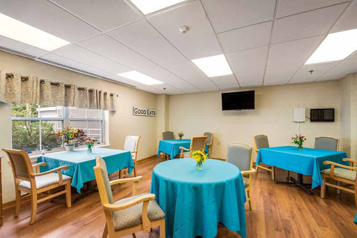 A bright and welcoming dining area with turquoise table covers, providing a cheerful atmosphere for gatherings.