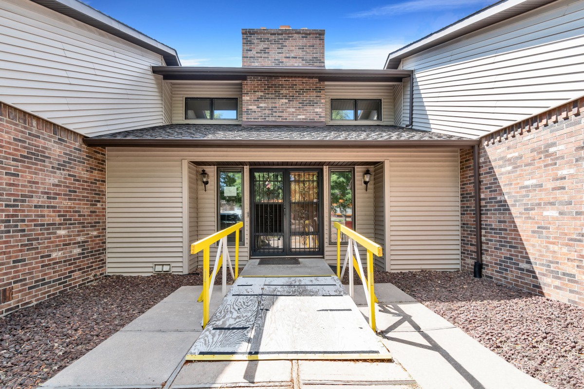 Front entrance of a residential building with a ramp.