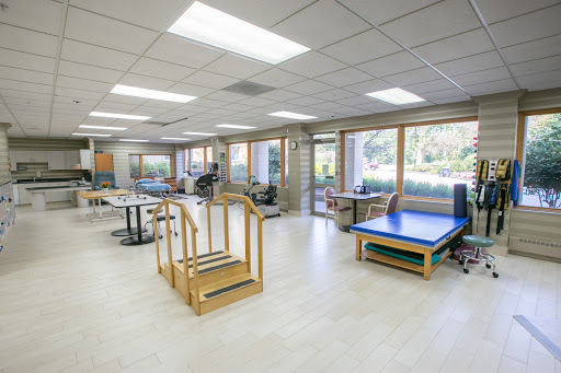 A bright and spacious rehabilitation therapy room equipped with various exercise tools.