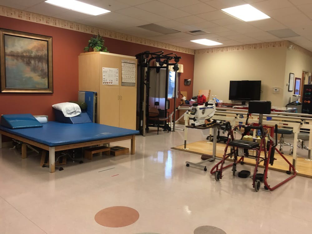 A rehabilitation room equipped with various physical therapy tools and exercise equipment.