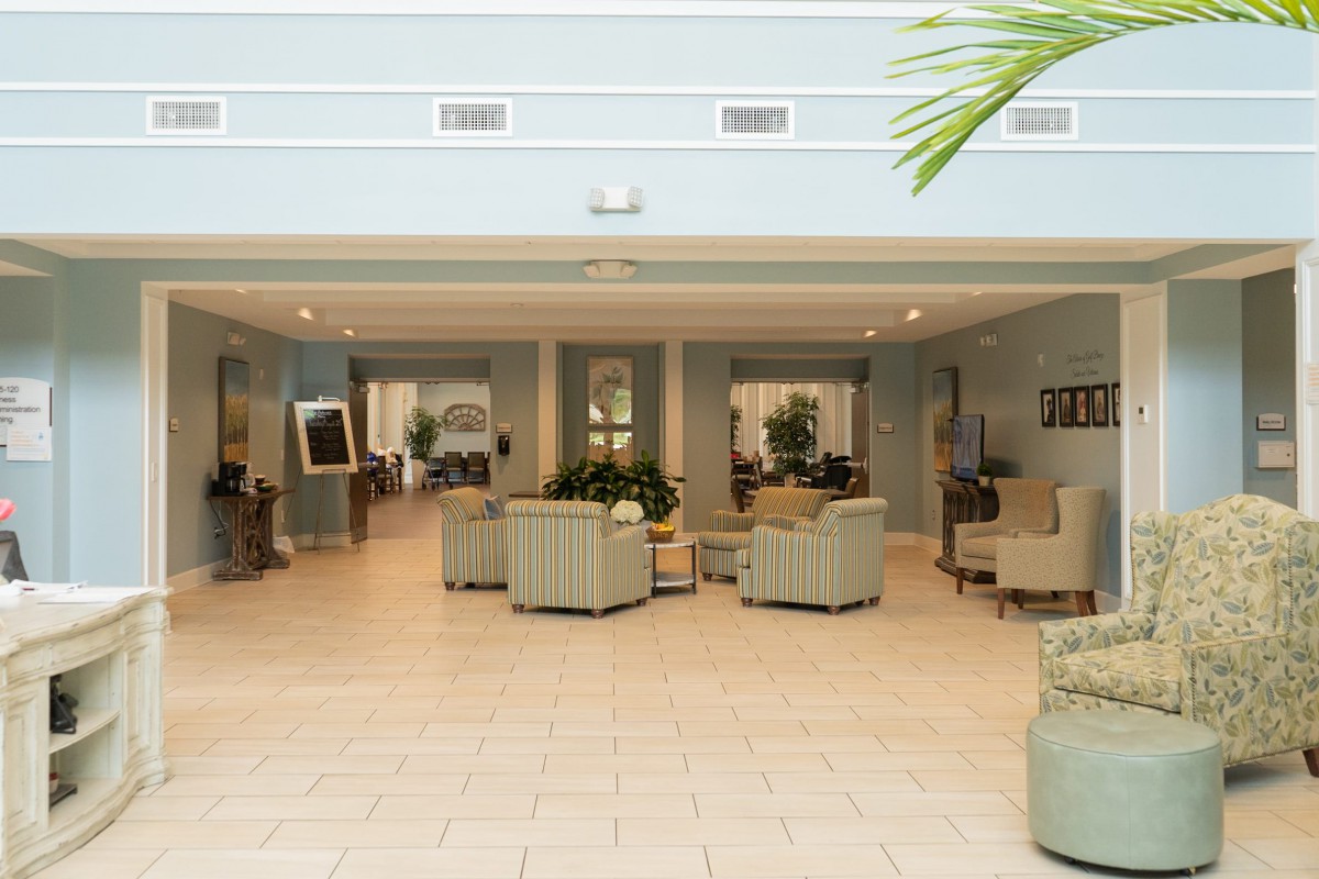 A spacious and modern lobby area with comfortable seating and decorative plants.