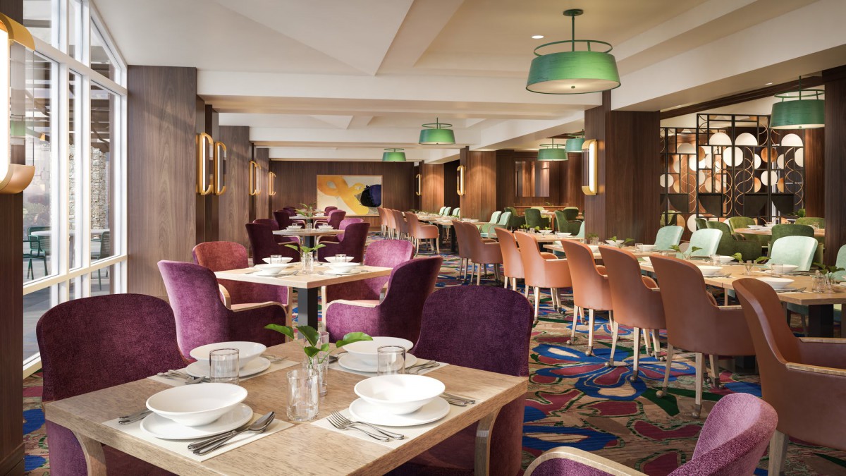 A modern restaurant interior with neatly arranged tables and chairs, ready for diners.