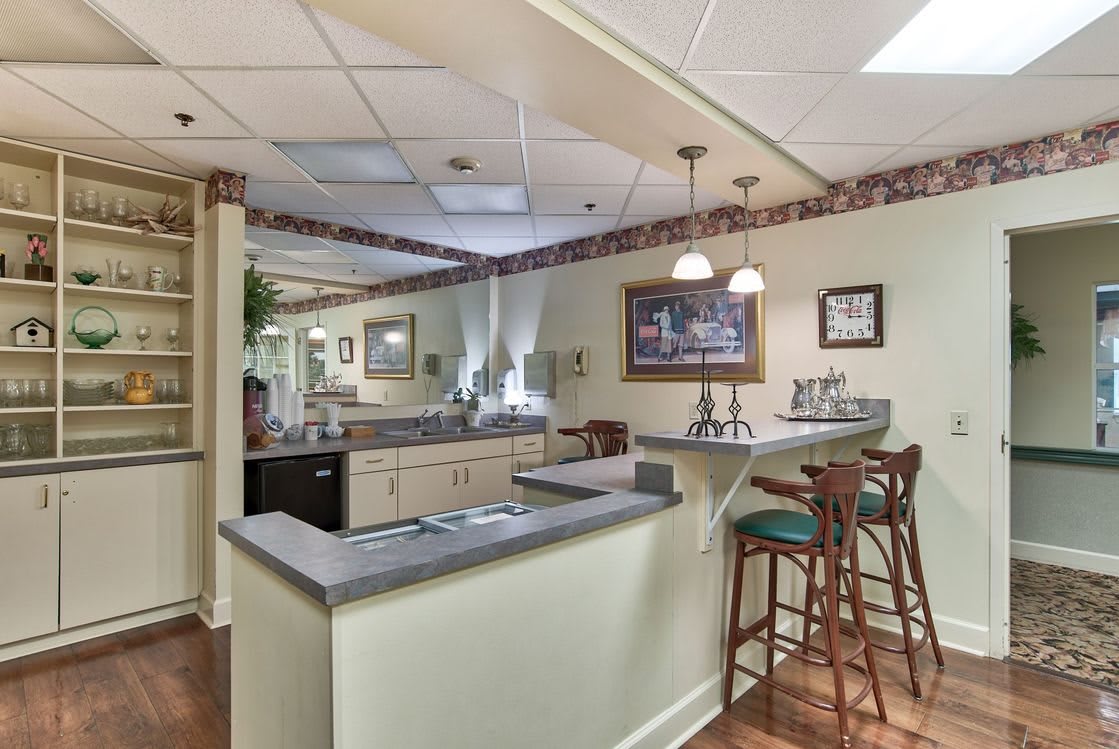 Home kitchen with a cozy bar seating area and warm lighting.