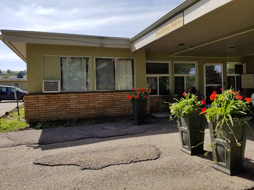 A view of a building with flower pots and an inviting entrance.