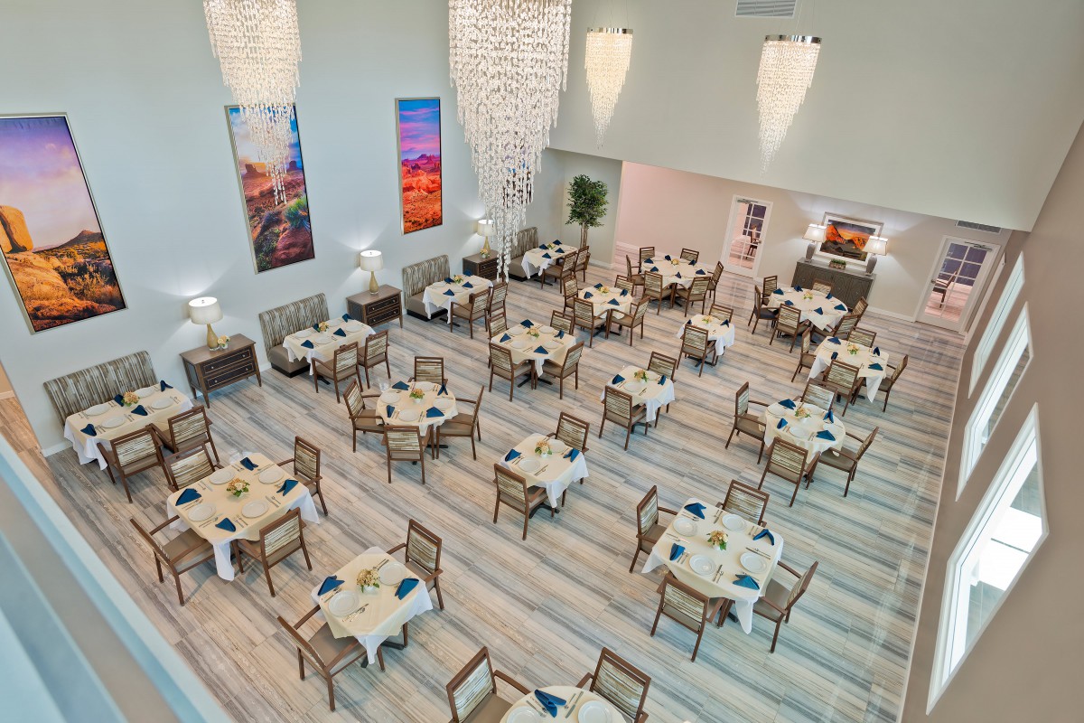 A modern dining room setup with neatly arranged tables and chairs, ready for guests.