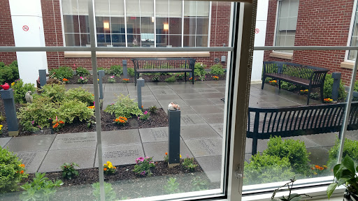 A view of a serene courtyard featuring benches and landscaped plants.