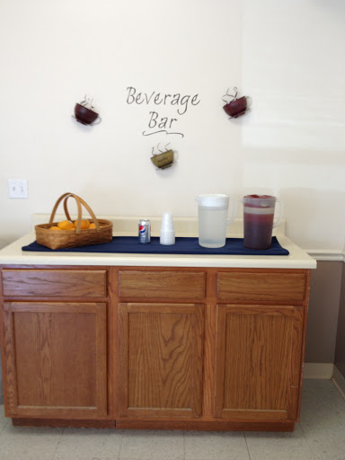 A cozy beverage bar setup featuring various drink containers and decorative elements.