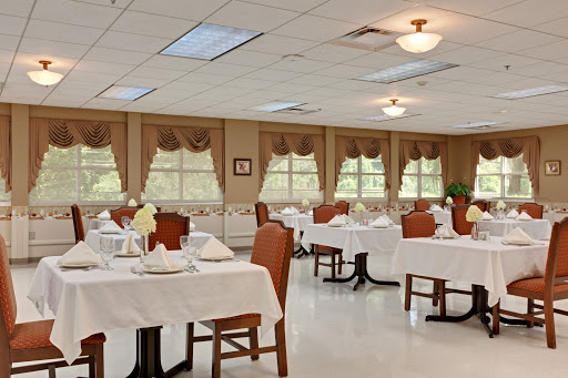 A spacious and elegantly arranged dining room with neatly set tables, ready for guests.