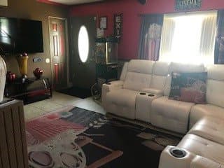 Cozy living room with comfortable seating and a television.