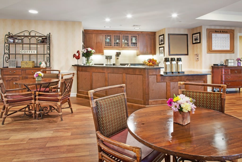 Cozy dining area with wooden furniture and floral decor.
