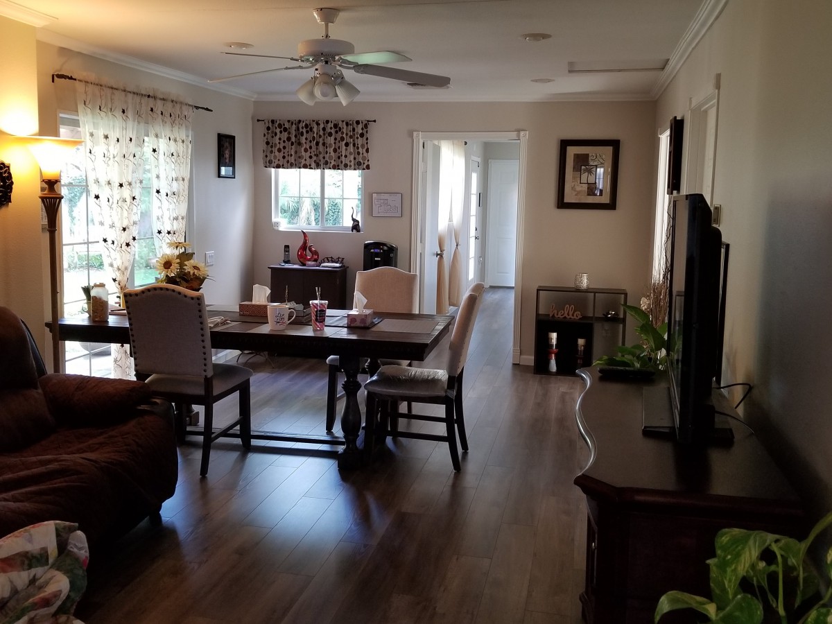 A cozy living room and dining area with warm lighting and elegant furnishings.