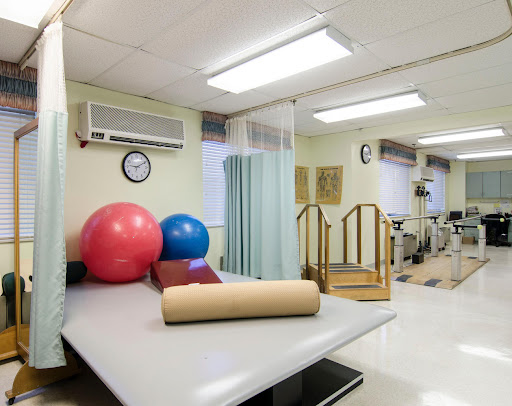 A well-equipped physical therapy room featuring various exercise tools and equipment designed for rehabilitation.