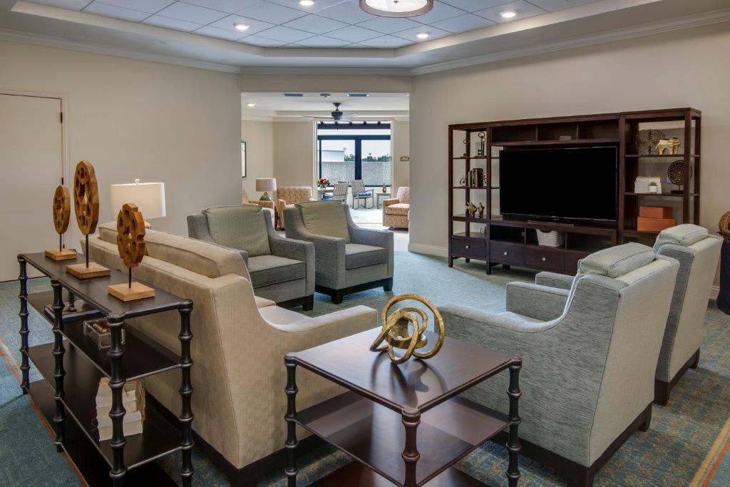 A modern living room with comfortable seating and a large television.