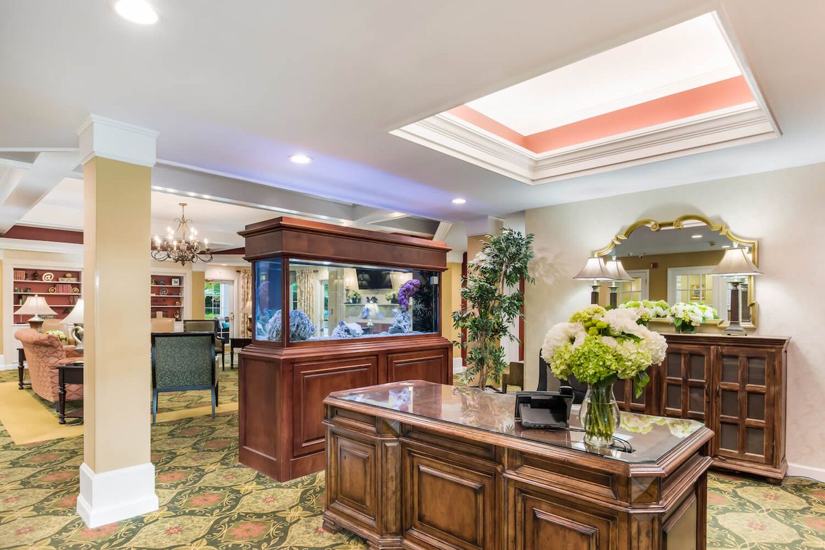 A well-decorated interior with a large aquarium and a reception desk.