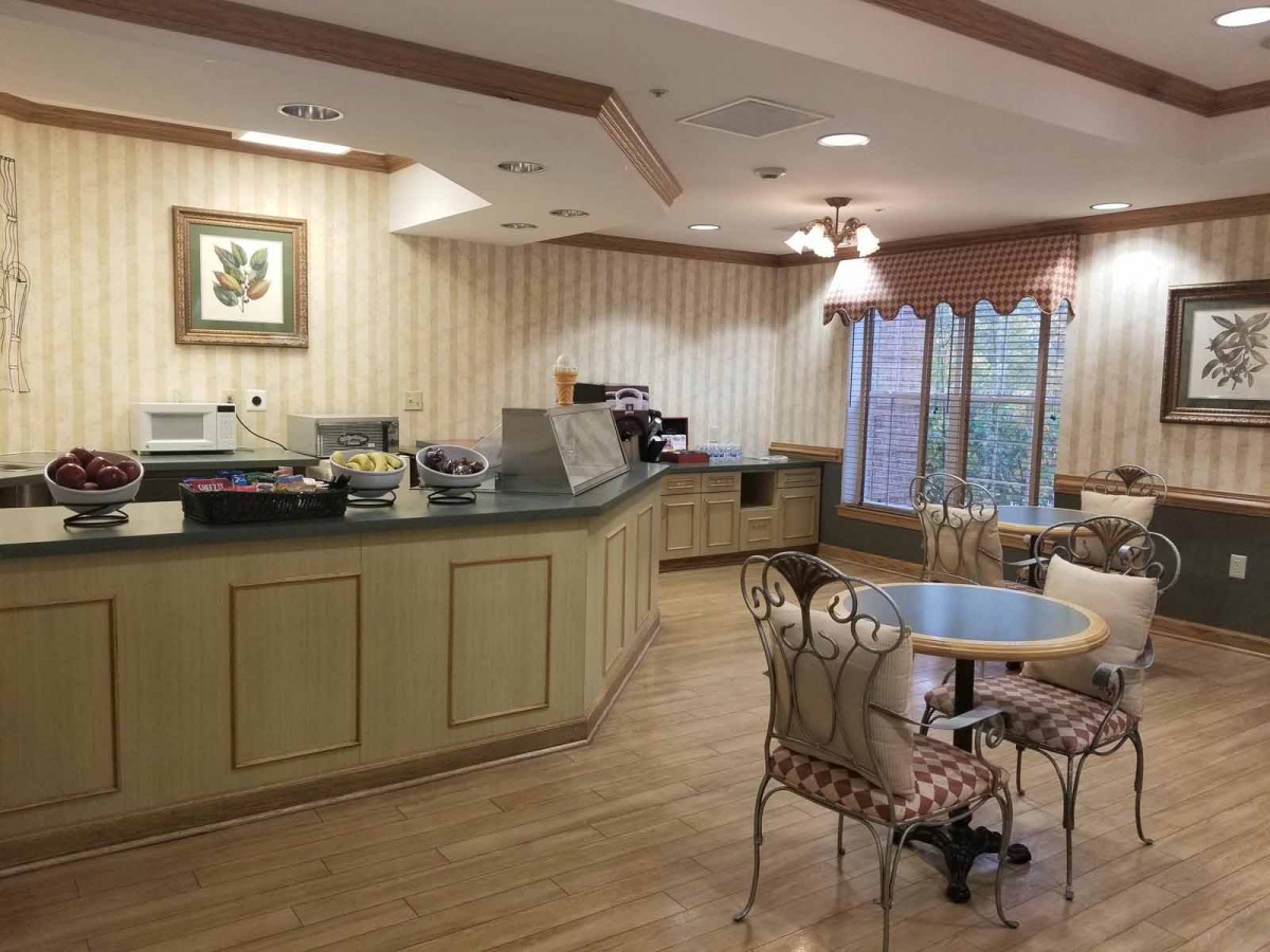 A cozy cafe interior with a serving counter and seating area.