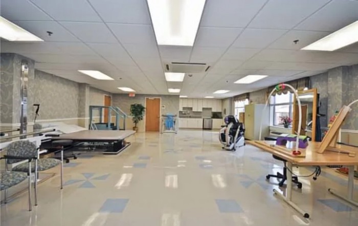 A spacious room with gym equipment and modern interior design.