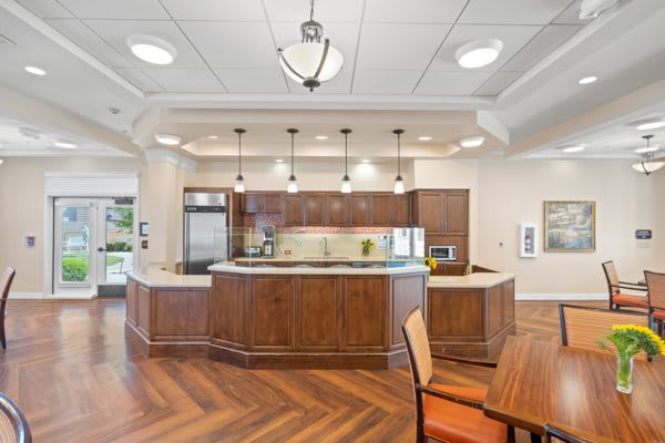 A modern kitchen interior with wooden floors and an island counter.