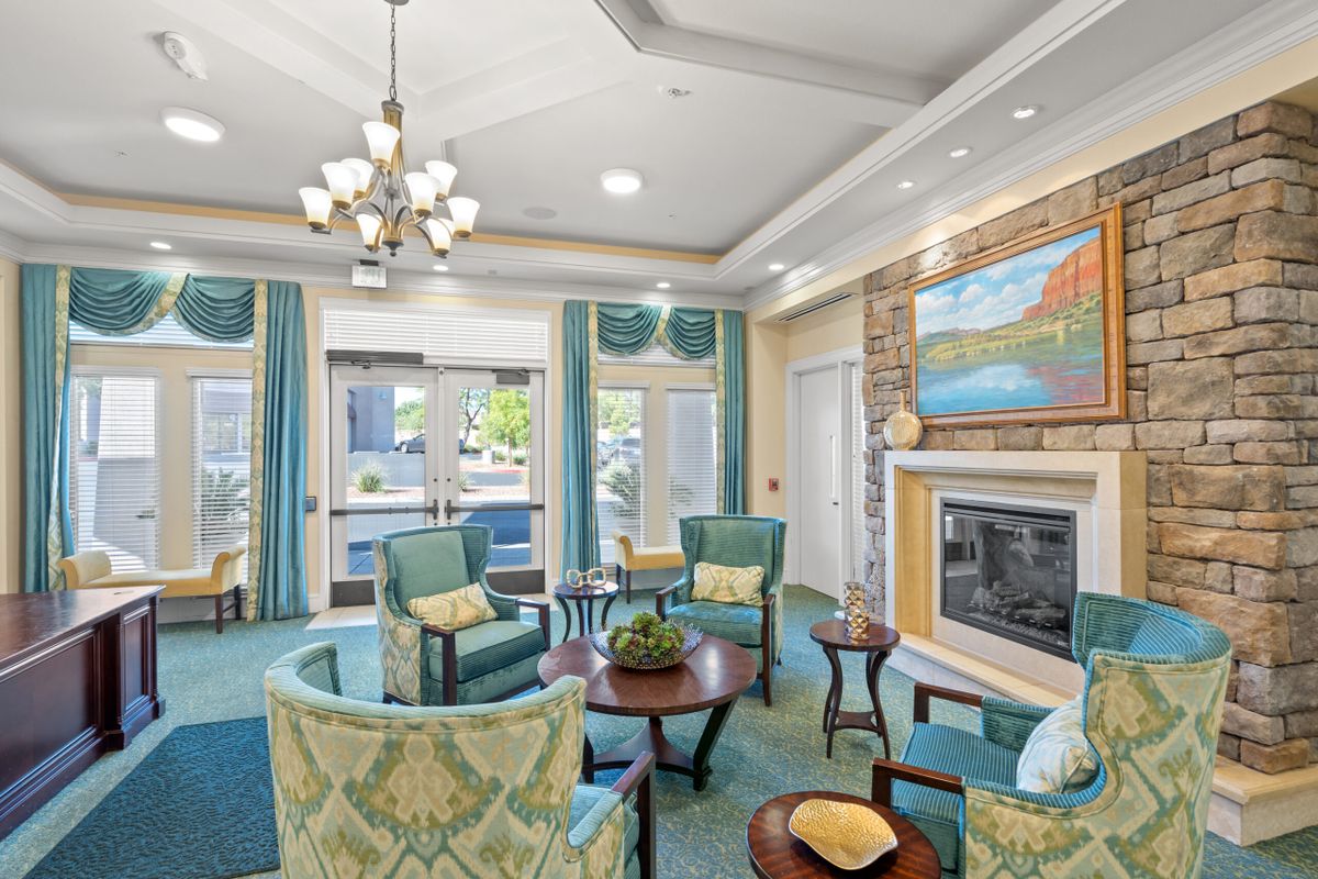 A modern lounge area with comfortable seating and a cozy fireplace.