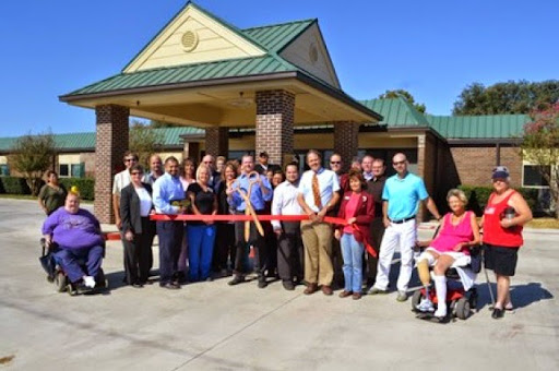 Community leaders and members gather for a ribbon-cutting ceremony to celebrate the opening of a new facility.