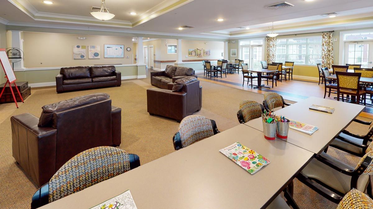 A spacious and well-lit living room with comfortable couches and tables designed for relaxation and social gatherings.