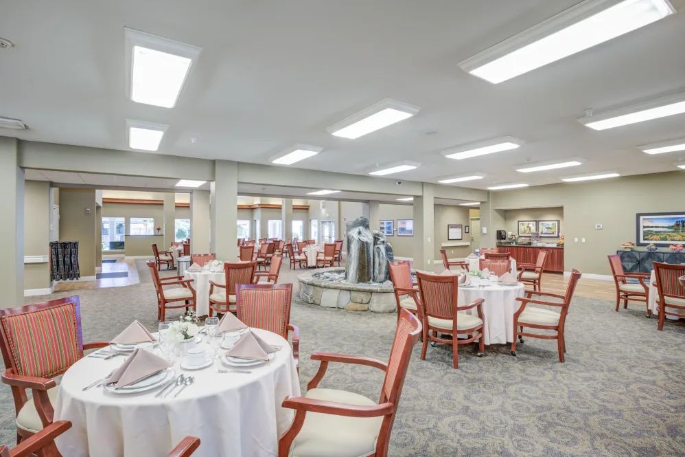 An elegant dining area with neatly arranged tables and chairs, set in a sophisticated restaurant interior.