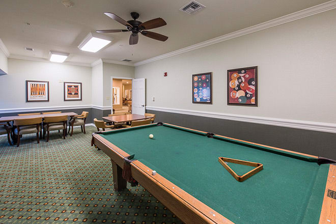 A cozy game room featuring a pool table and seating area.