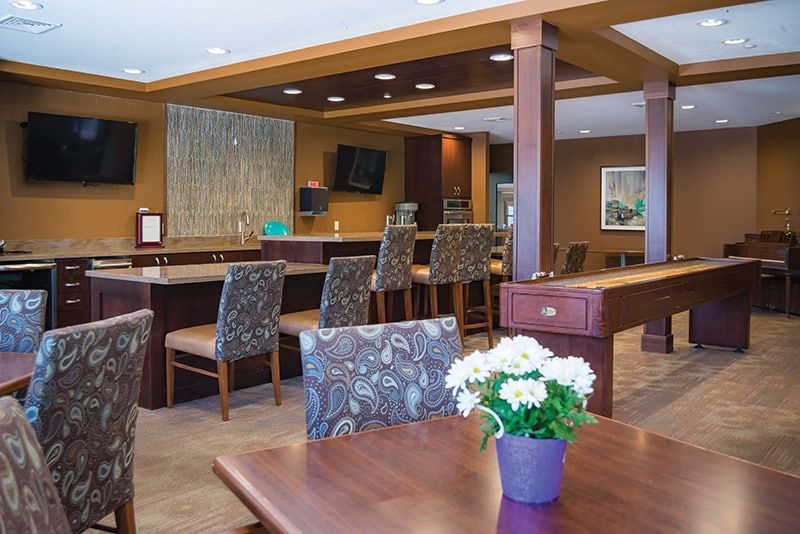 A modern seating area with a bar and decorative elements.
