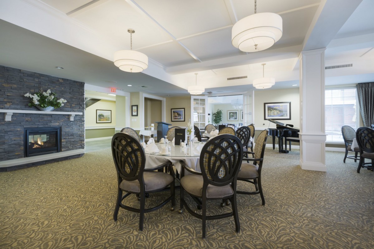 A modern dining room interior with elegant furniture and chandeliers.