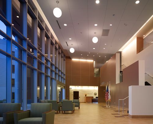 A modern lobby with comfortable seating and a reception desk.