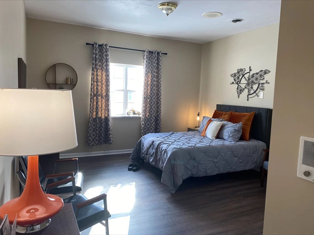 A cozy bedroom with modern decor and a comfortable bed.