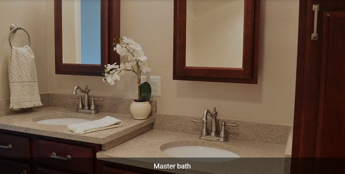 Elegant master bathroom with a clean sink area and floral decor.